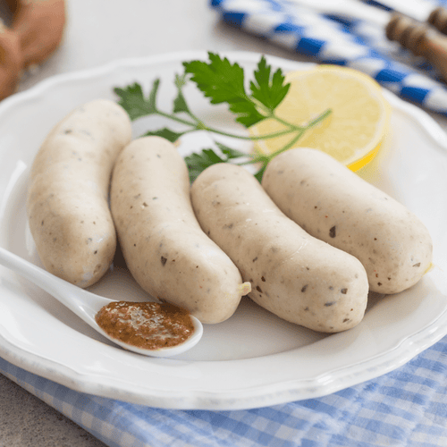 German Weisswurst, four pale Bavarian white sausages in natural casing