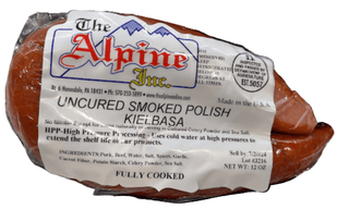 Packaged Uncured Smoked Polish Kielbasa from The Alpine Inc. on a marble surface.