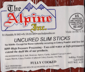 PackagedUncured Slim Sticks with Alpine Inc. label on a marble surface