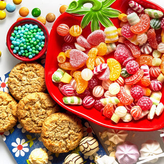Assorted candies, cookies, and ice cream on a colorful background